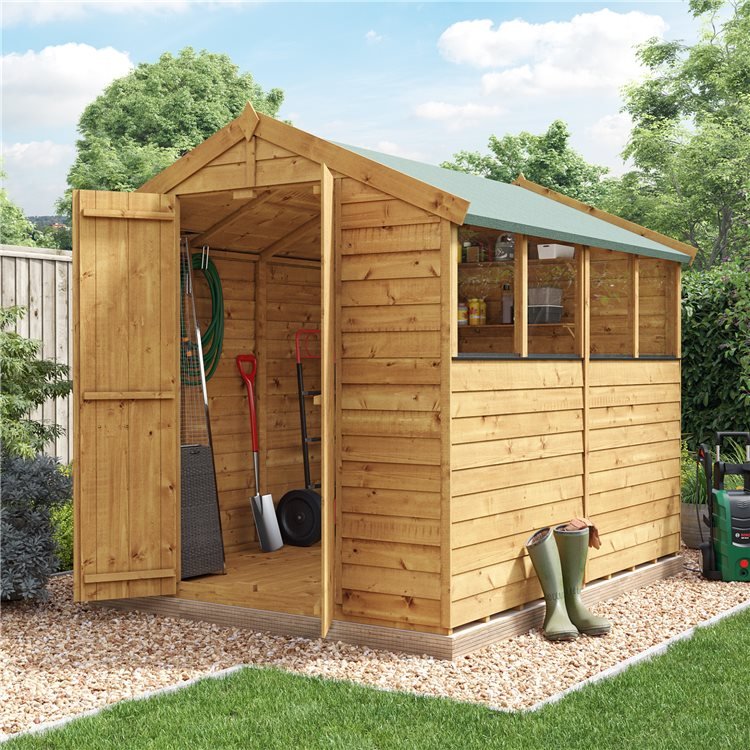 Windowed wooden shed with open double doors in cosy green garden